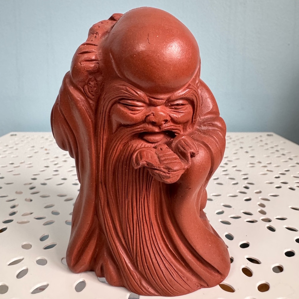 Purple clay figurine of Chinese God of Longevity.